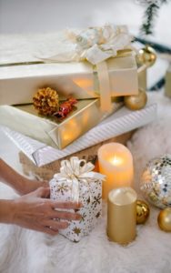 Stack of gifts wrapped in gold and white wrapping paper