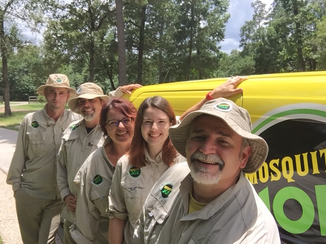 Team members of Mosquito Joe of NW Houston-S Brazos Valley standing in front of a transit