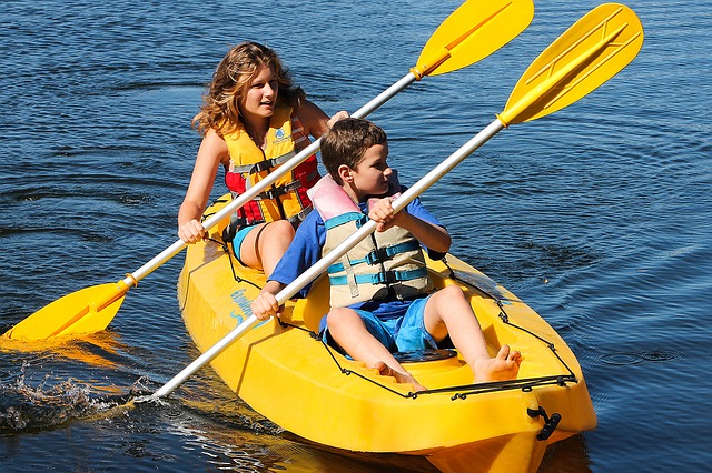 Mom and son kayaking on a lake