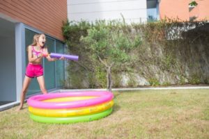 girl playing with water tube