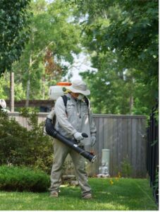 Mosquito Joe of NW Houston and S Brazos Valley Lead Technician, Kyle Luna, treating a yard for mosquitoes. 